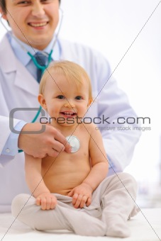 Baby being checked by pediatrician doctor using stethoscope