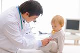 Baby on examination being checked by pediatric doctor