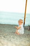 Lonely baby playing on beach