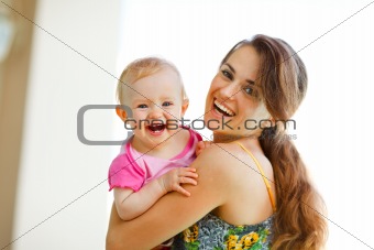 Portrait of laughing mother and baby