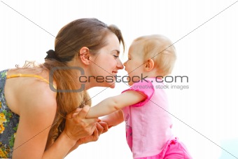 Young mother playing with baby