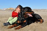 rottweiler and child on the beach