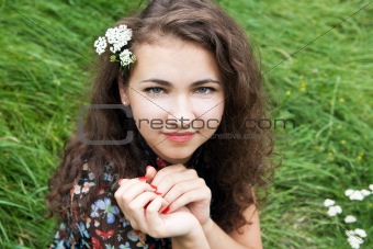 Portrait of a beautiful young brunette with flowering branches