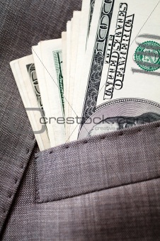 dollars in the pocket of business suit