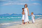 Young mother with her two kids on beach vacation