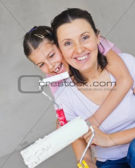 Happy Mother and douther painting a wall