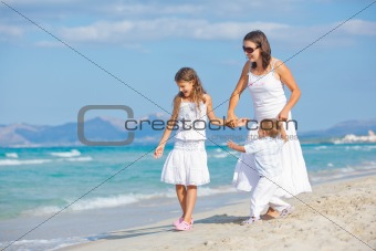 Young mother with her two kids on beach vacation