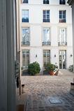 Private Parisian Interior Cobblestone Courtyard and Apartment Building.