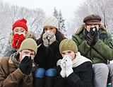Group of friends with colds outside in winter