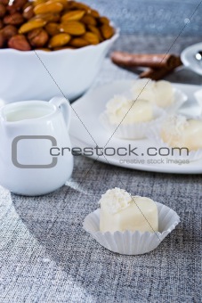 Chocolates in heart shaped white chocolate on the tablecloth