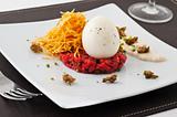 Gourmet dish with egg and raw meat. 