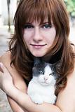 A beautiful young brunette and a cat