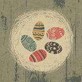 Easter eggs in nest on wooden texture. Easter background, retro 