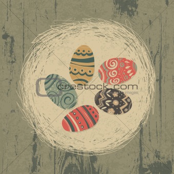 Easter eggs in nest on wooden texture. Easter background, retro 