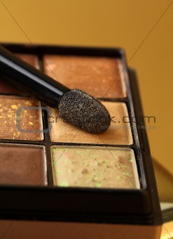 gold eyeshadow palette with a brush