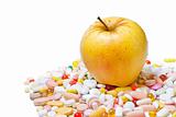 Apple and pills on white background