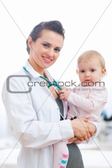 Portrait of pediatrician doctor with baby