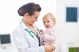 Pediatrician doctor with baby on examination