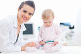 Pediatric doctor with baby on survey