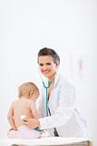Pediatrician doctor examine baby using stethoscope
