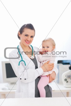 Pediatric doctor with baby on survey