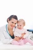 Portrait of laughing pediatrician doctor and baby