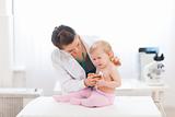 Pediatric doctor examine crying baby
