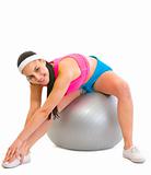 Slim girl making exercises on fitness ball