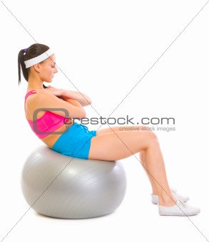 Fitness girl making abdominal crunch on fitness ball