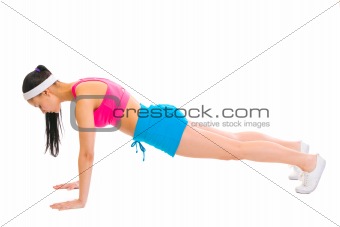 Healthy female making push up exercises