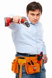 Construction worker pointing electric screwdriver as a gun in camera