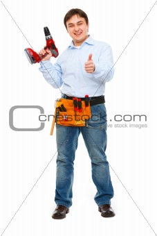 Full length portrait of construction worker with drill showing thumbs up