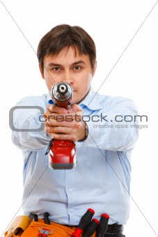 Construction worker pointing drill as a gun in camera