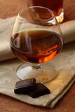 glass of brandy and chocolate pieces