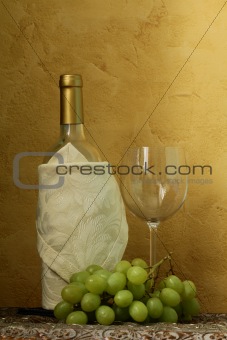 still life of wine bottles, glass and green grapes for vintage table