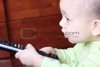 little child with a TV remote control