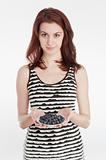 Young woman holding a plate with blueberries