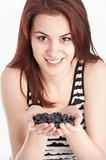 Young woman holding blueberries in her hands