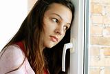 Teenage girl looking out  window