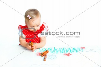 little girl drawing with crayons
