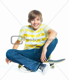 blond boy on sitting on skateboard