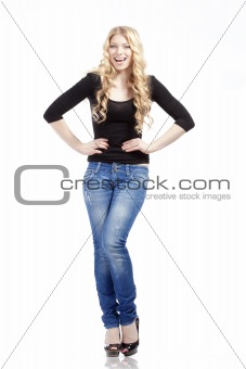 young woman with blond hair in jeans and black top - isolated on white