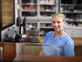 Woman working as nurse at reception desk in clinic