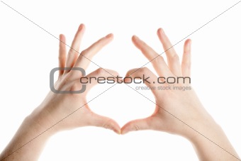Female hands making heart sign