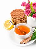 tea in cup with biscuits and lemon