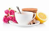 tea in cup with biscuits and lemon