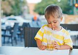 portrait of adorable little boy drinking juice