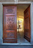 Ornate wooden door. La Morra, Italy.