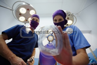 Operation room in clinic with medical staff during surgery