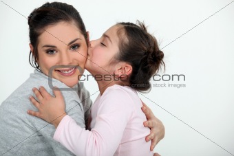 Daughter kissing her mum